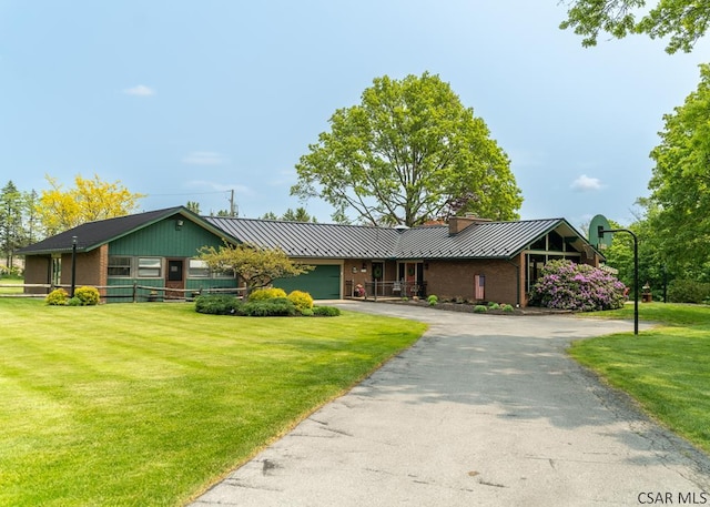 single story home with a garage and a front lawn