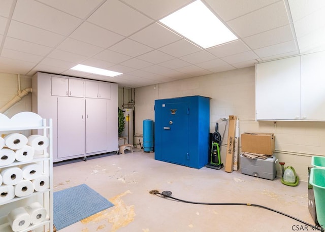 basement with gas water heater and a paneled ceiling