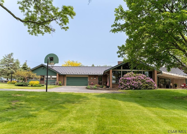 ranch-style house featuring a garage and a front yard