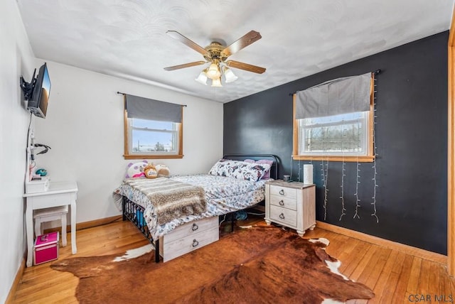 bedroom with ceiling fan and light hardwood / wood-style flooring