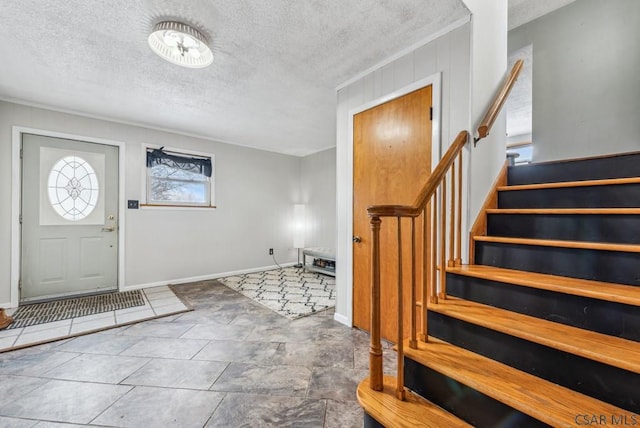 foyer entrance featuring a textured ceiling