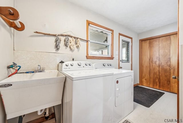 washroom with sink and washing machine and clothes dryer