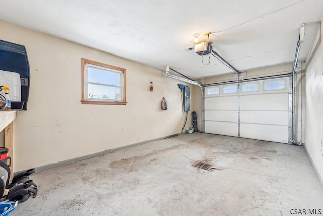 garage featuring a garage door opener and electric panel