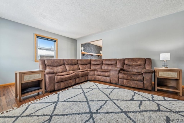 living room featuring wood-type flooring and a textured ceiling