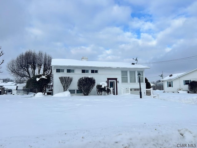 view of snow covered rear of property