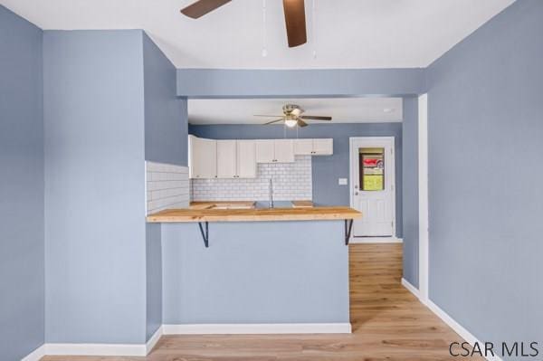 3445 Graham Ave, Windber, PA 15963 - kitchen featuring a ceiling fan, a peninsula, and wooden counters