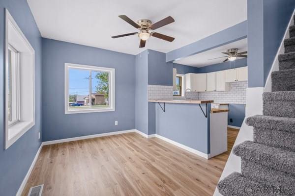 3445 Graham Ave, Windber, PA 15963 - unfurnished living room with stairway, ceiling fan, and light wood-style floors
