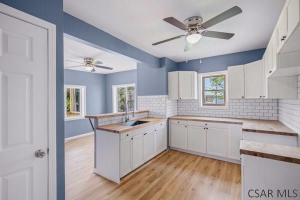 3445 Graham Ave, Windber, PA 15963 - kitchen featuring a peninsula, wooden counters, light wood-style floors, and ceiling fan