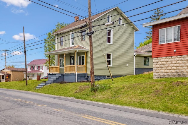 3445 Graham Ave, Windber, PA 15963 - view of front of property with covered porch, a front yard, and a chimney