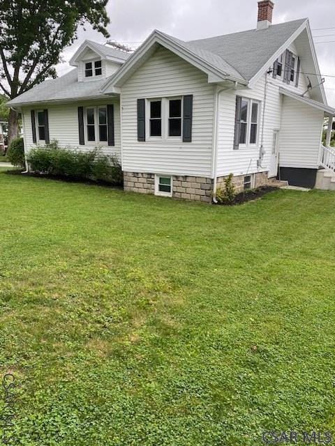 rear view of house with a yard