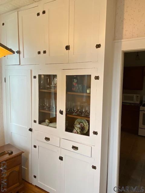 bar featuring white range and white cabinets