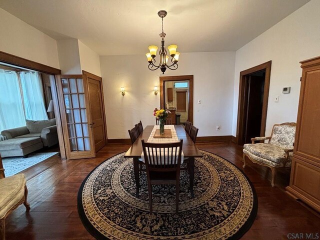 dining room featuring dark hardwood / wood-style floors and a chandelier