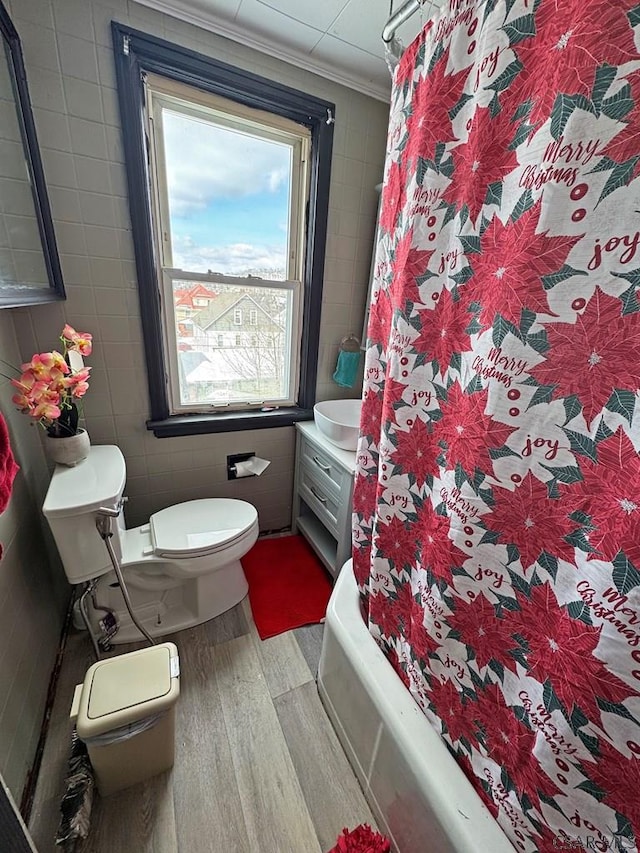 bathroom with tile walls, vanity, toilet, and hardwood / wood-style flooring