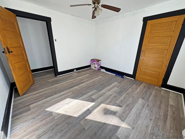 interior space with ceiling fan and wood-type flooring