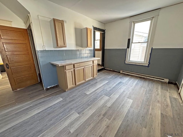 kitchen featuring a baseboard radiator, light wood-type flooring, and light brown cabinetry