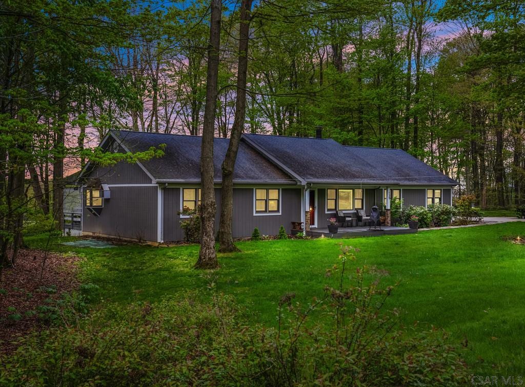 139 Wenatchee Ln, Central City, PA 15926 - back of property at dusk featuring a lawn and covered porch