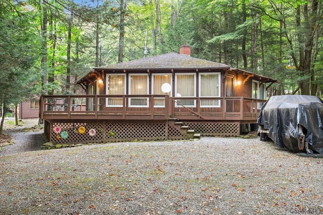 back of property featuring a wooden deck