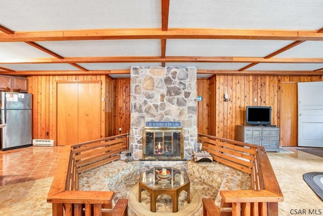 living room with coffered ceiling, light tile patterned floors, a fireplace, and wooden walls