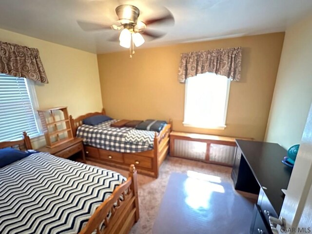 bedroom featuring ceiling fan and light carpet