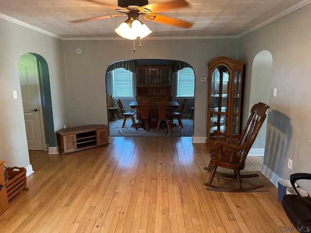 dining space with ornamental molding, light hardwood / wood-style floors, and ceiling fan