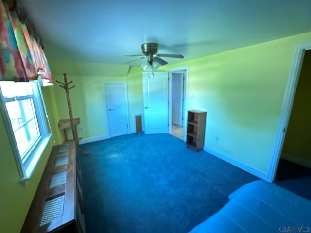 carpeted spare room with ceiling fan