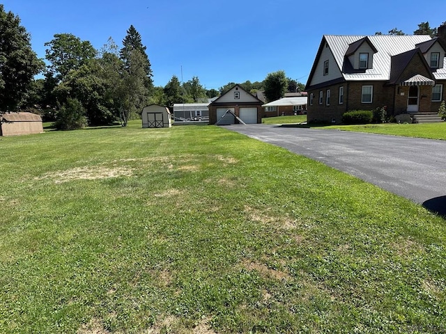 view of yard with a storage shed and a garage