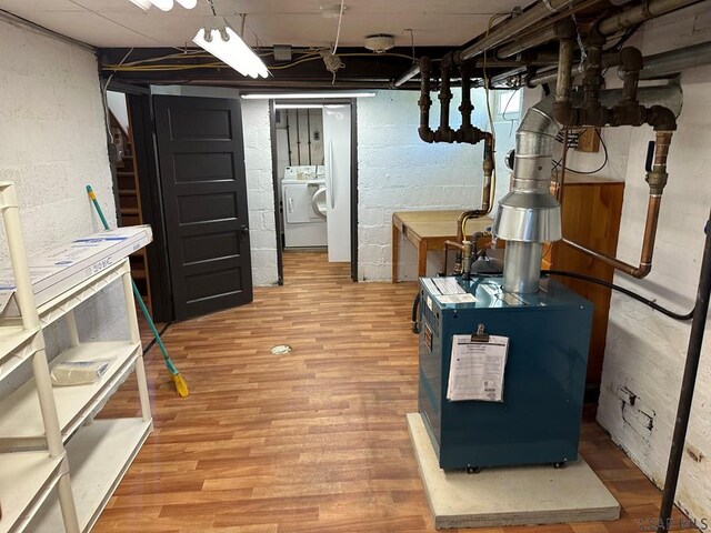 basement featuring washer / clothes dryer and light wood-type flooring