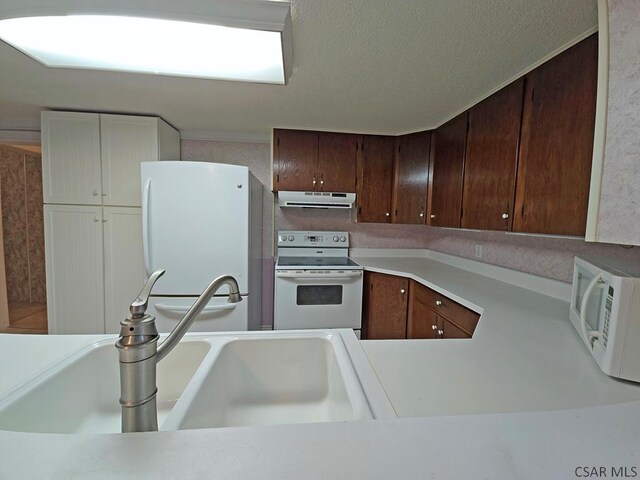 kitchen featuring sink and white appliances