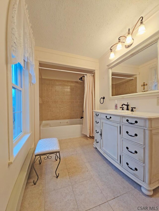 bathroom with vanity, a textured ceiling, tile patterned floors, and shower / bath combo