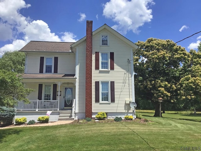 front facade featuring a front yard and covered porch