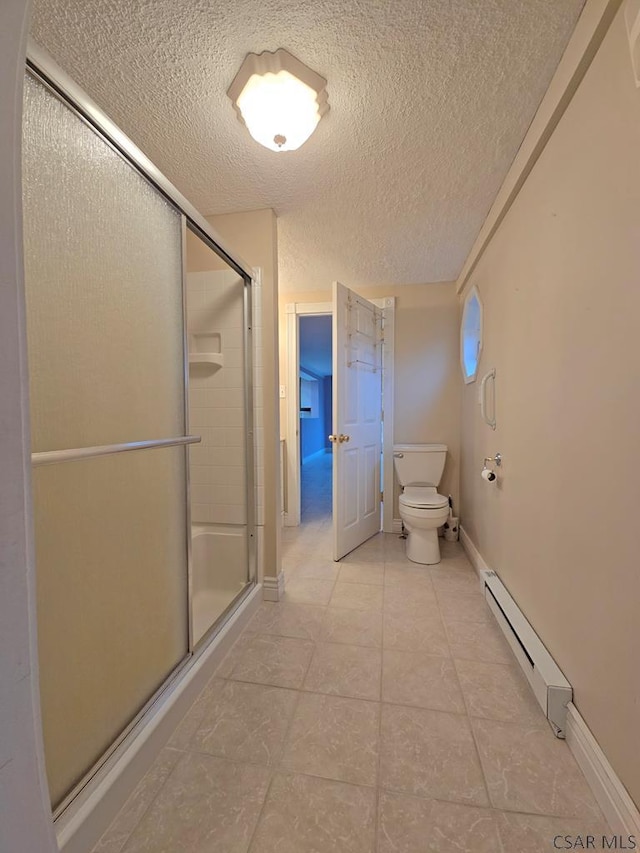 bathroom with walk in shower, a textured ceiling, toilet, and baseboard heating