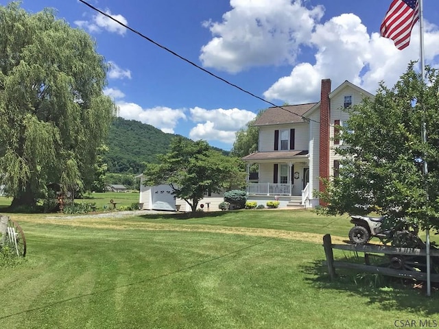 view of yard with a garage and covered porch