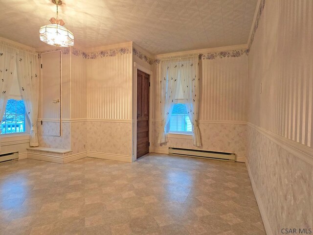 unfurnished room with ornamental molding and baseboard heating