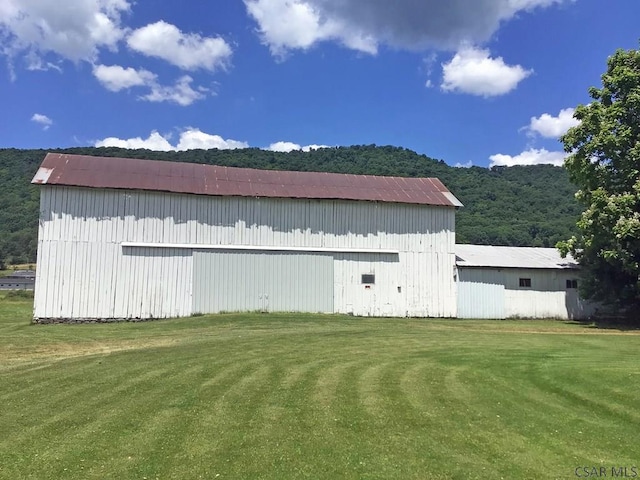 view of outbuilding featuring a lawn