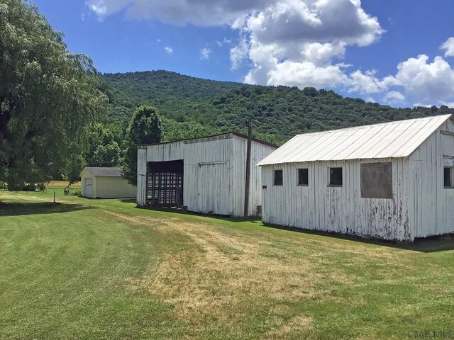 view of outdoor structure featuring a lawn