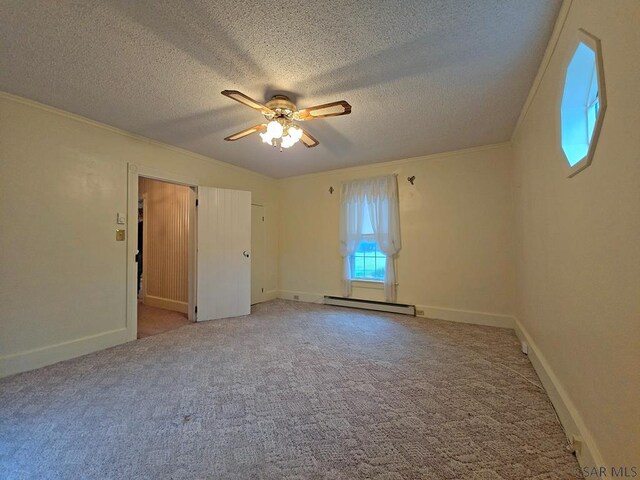 carpeted spare room with a baseboard radiator, crown molding, ceiling fan, and a textured ceiling