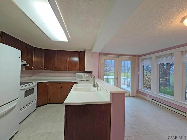 kitchen with sink, dark brown cabinetry, kitchen peninsula, white appliances, and french doors