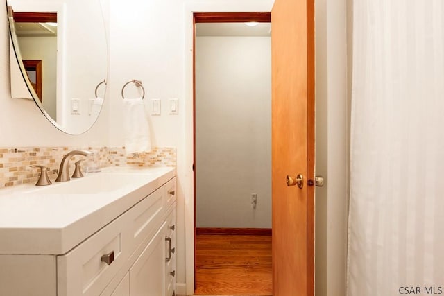 129 Berkey Dr, Johnstown, PA 15904 - bathroom with vanity, wood finished floors, and decorative backsplash
