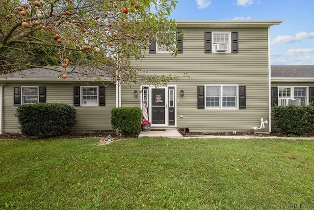 view of front of home featuring cooling unit and a front lawn