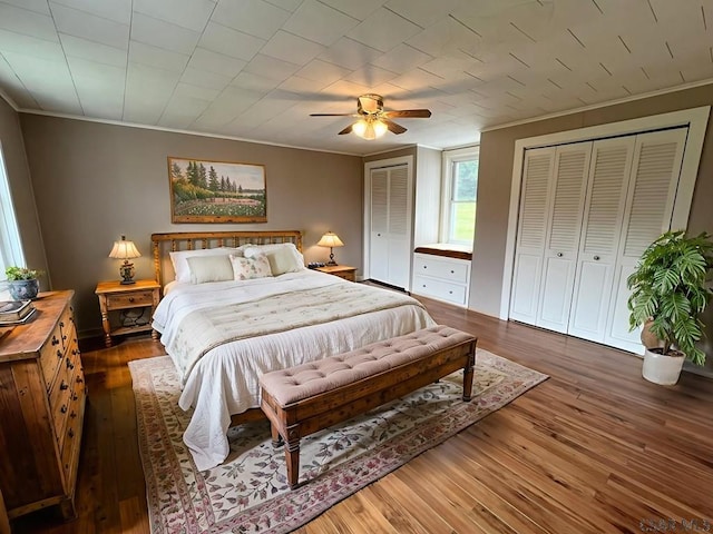 328 Thatcher Rd, New Florence, PA 15944 - bedroom featuring ornamental molding, two closets, wood-type flooring, and ceiling fan