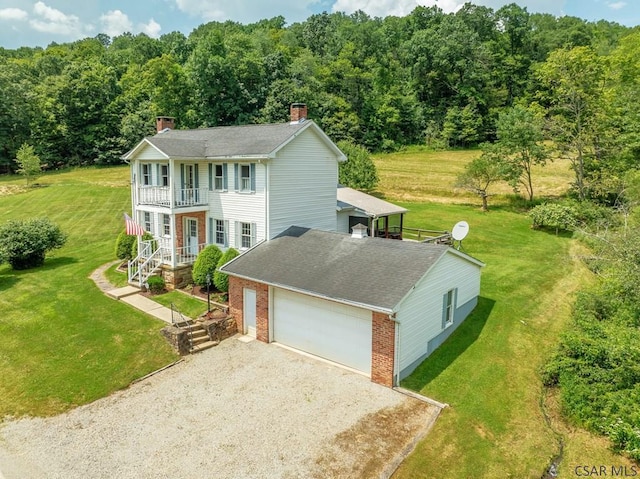 328 Thatcher Rd, New Florence, PA 15944 - colonial-style house with a balcony, a chimney, brick siding, driveway, and a front yard