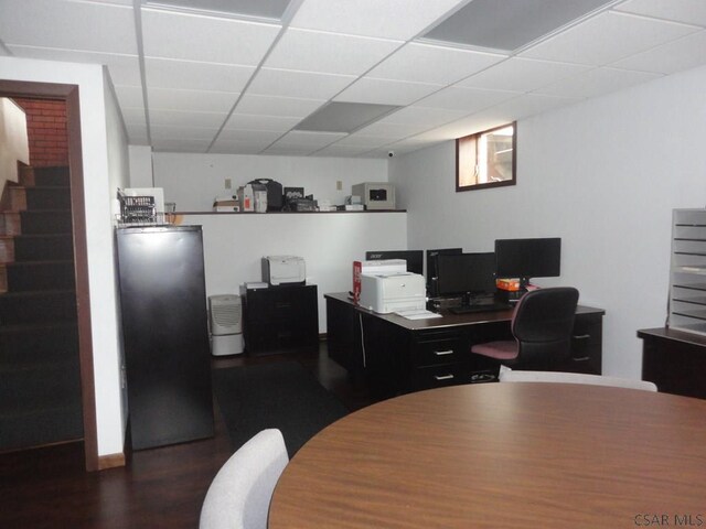 office with a drop ceiling and wood finished floors
