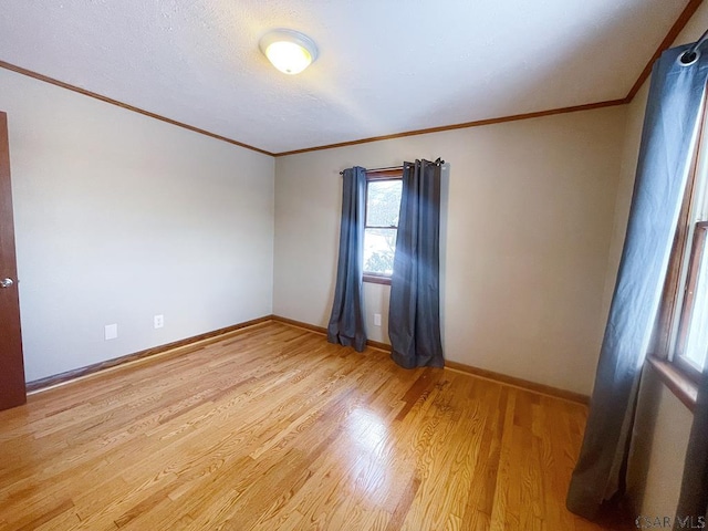 unfurnished room featuring crown molding and light hardwood / wood-style flooring