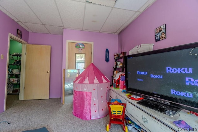 rec room with carpet floors and a drop ceiling