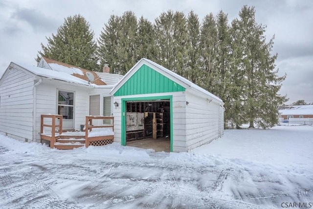 view of front facade featuring a garage and an outbuilding