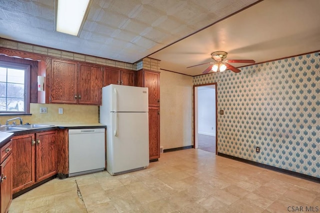 kitchen featuring ceiling fan, sink, and white appliances