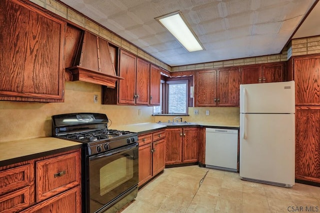 kitchen with sink, white appliances, and premium range hood