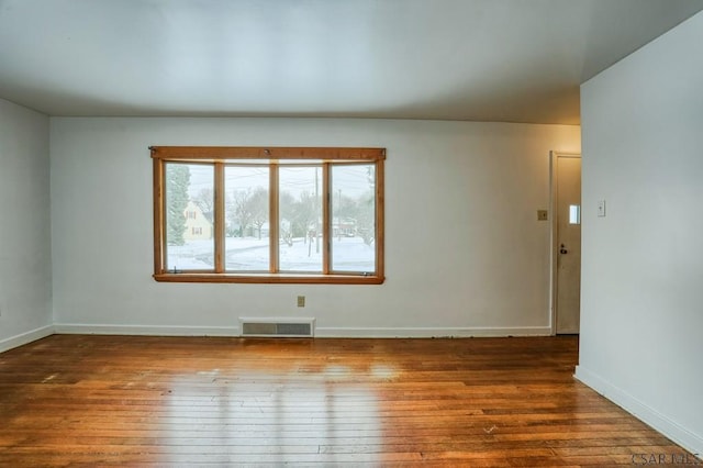 unfurnished room featuring hardwood / wood-style flooring