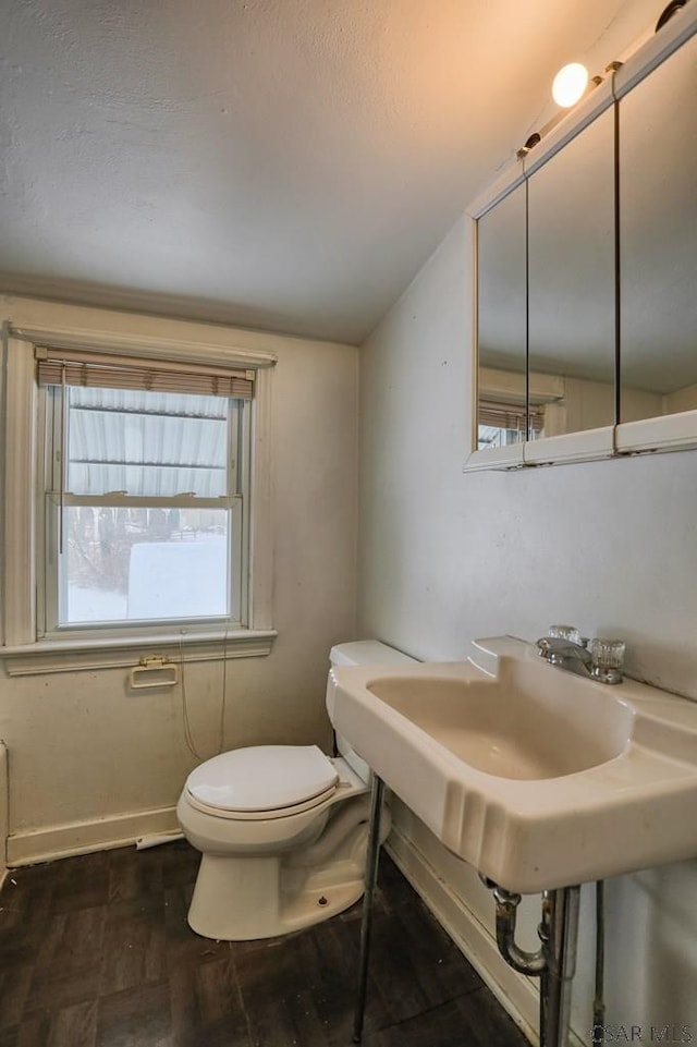 bathroom featuring vaulted ceiling and toilet