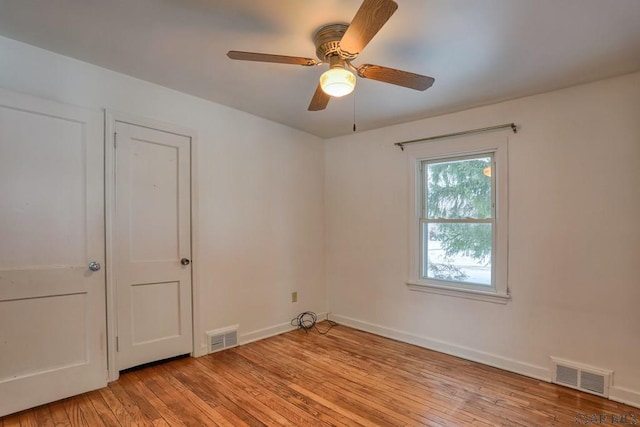 spare room featuring ceiling fan and light hardwood / wood-style floors